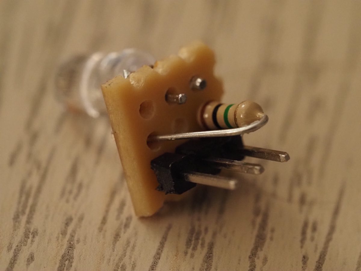 The photodiode sensor: a clear photodiode, a 1 MΩ resistor and a three-pin header on a tiny square of veroboard.